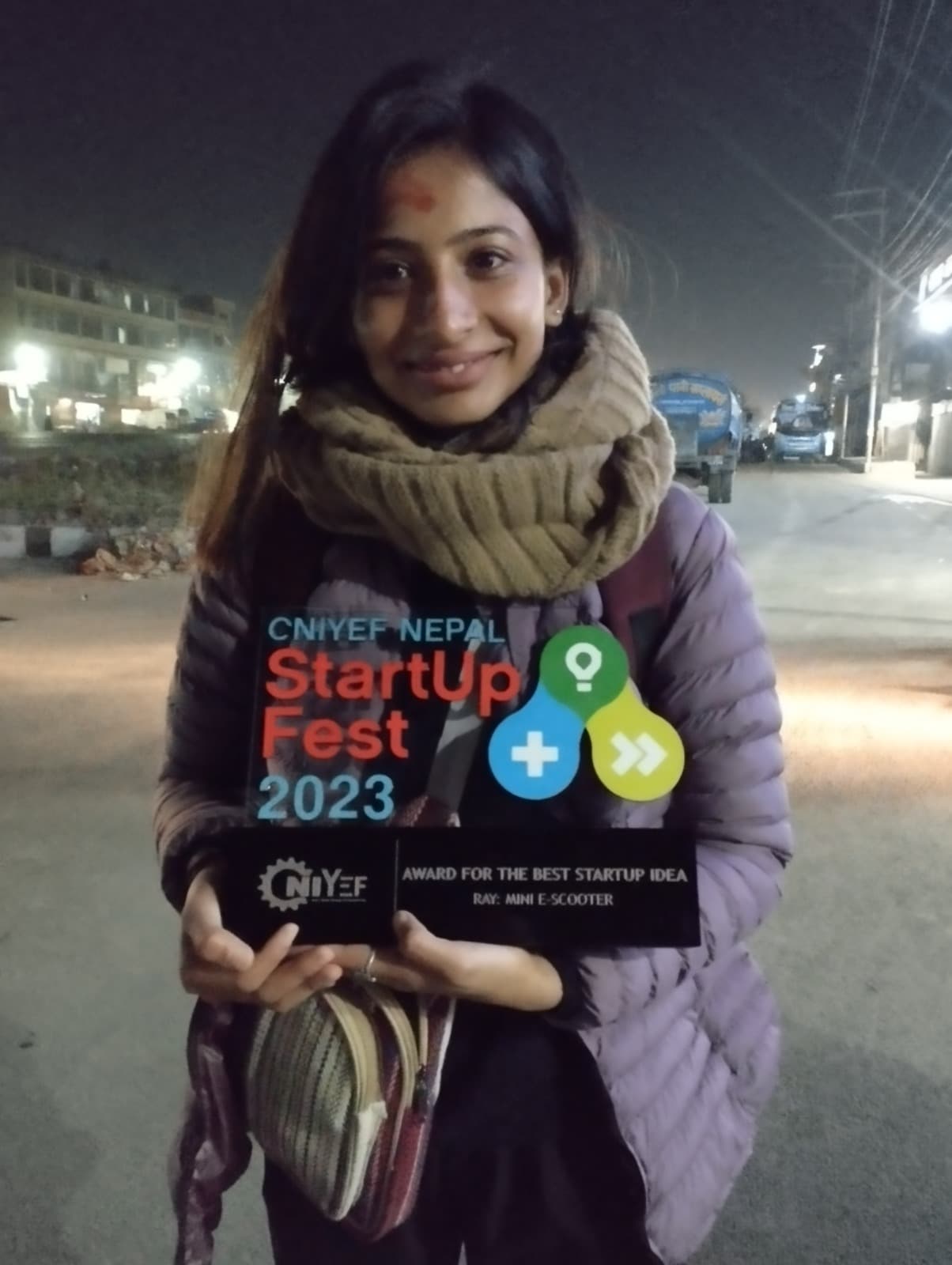 Holding the award for Best Startup Idea for Ray: Mini E-Scooter at CNIYEF Nepal StartUp Fest 2023