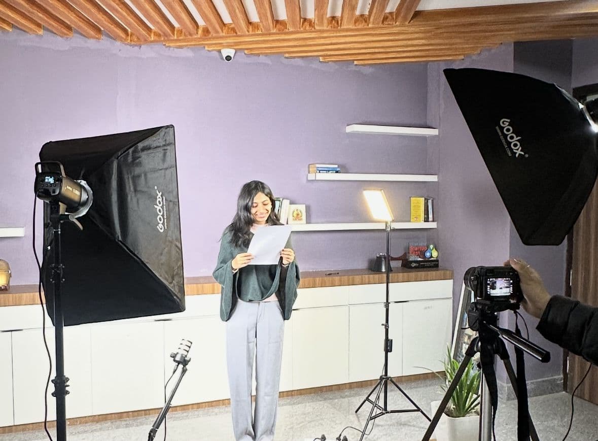 Behind the scenes of a video shoot with studio lighting